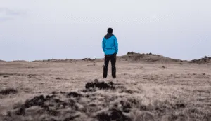 man standing on a rock alone in nature