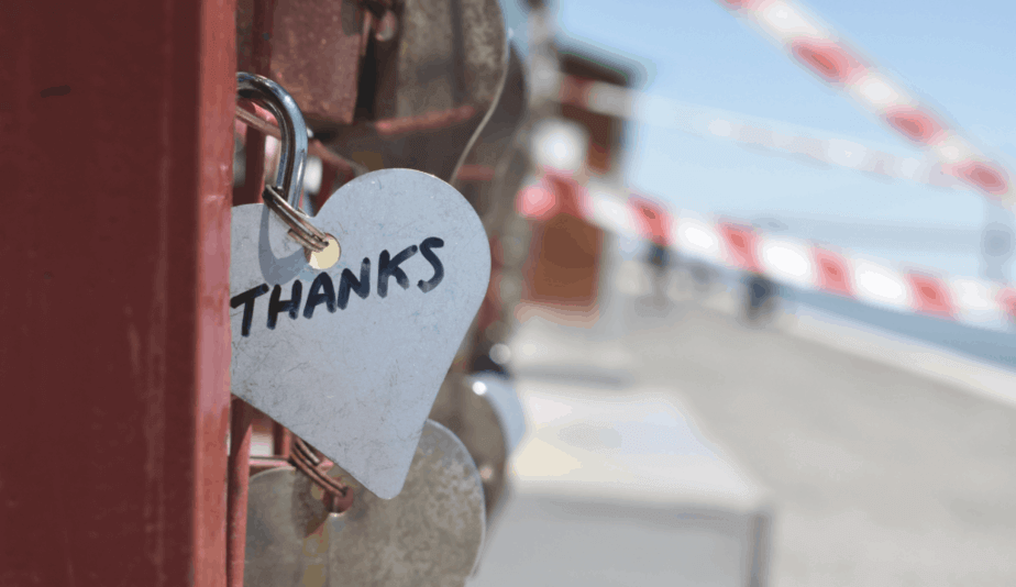 a padlock with thanks written on it attached to a fence