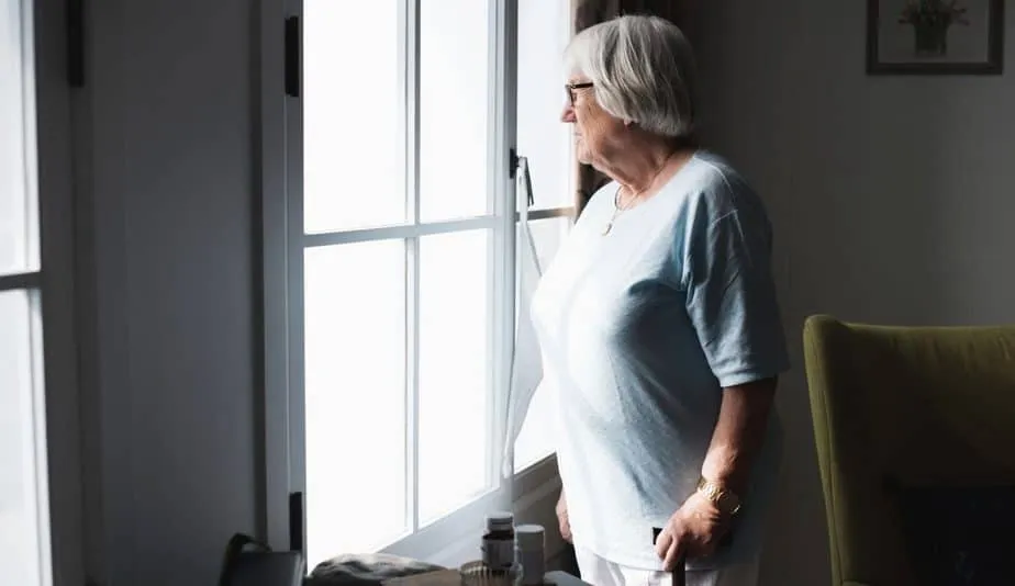 senior lady looking out the window