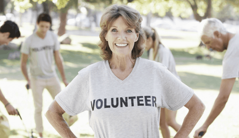 senior volunteer lady looking at the camera in a park