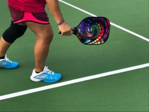 person holding a pickleball racquet