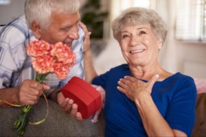 senior man giving an older woman a present