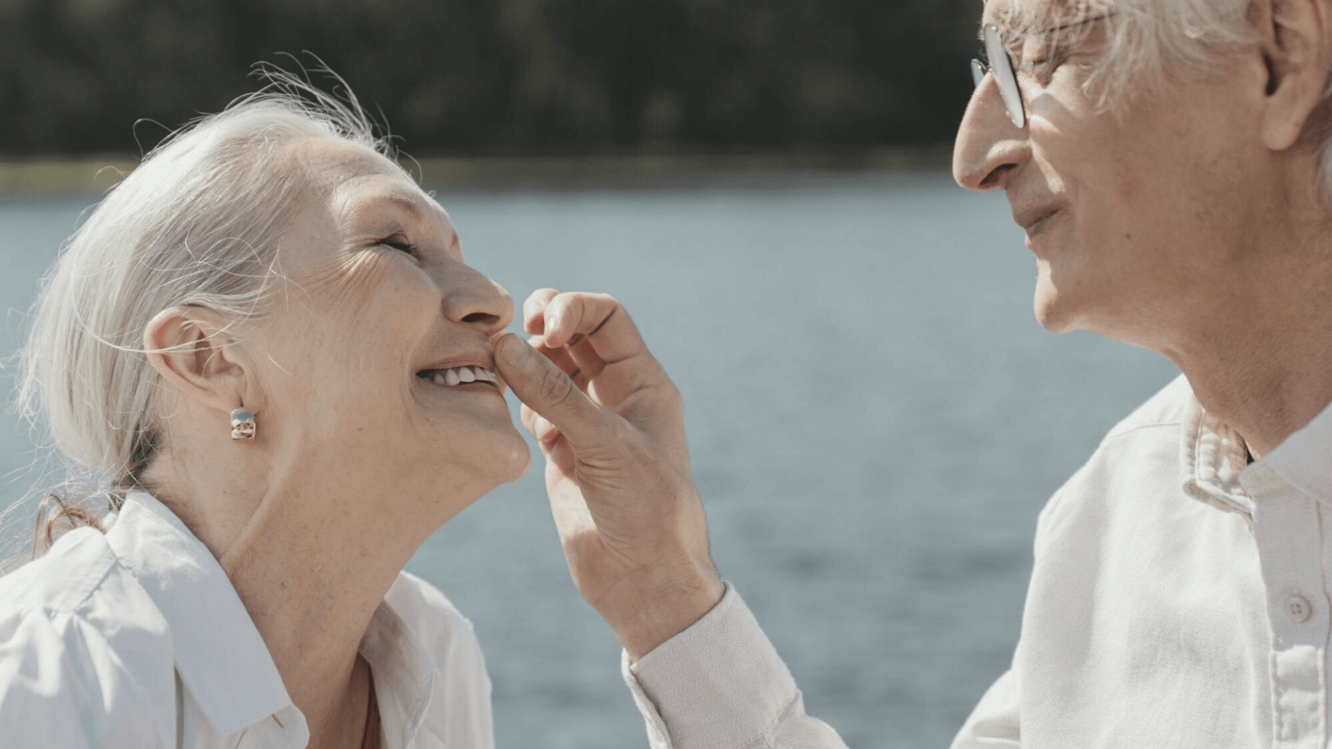 senior couple laughing and enjoying at a body of water