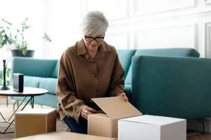 woman-unpacking-brown-boxes-living-room