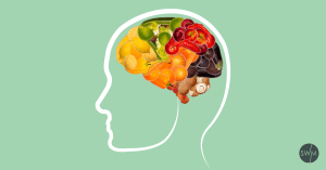 brain made out of fruits and vegetables on a light green background