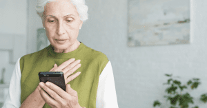 scared senior woman looking at her phone