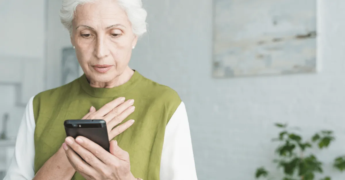 scared senior woman looking at her phone