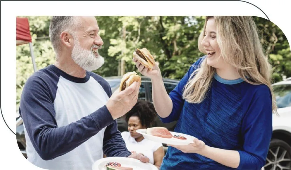 older man enjoying a barbecue with a female friend