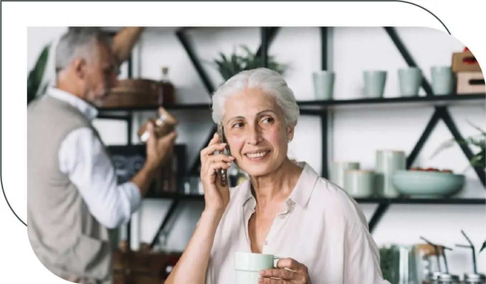 older woman talking on the phone in her kitchen