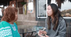 Cyn, a retirement coach, talking to a client on a patio