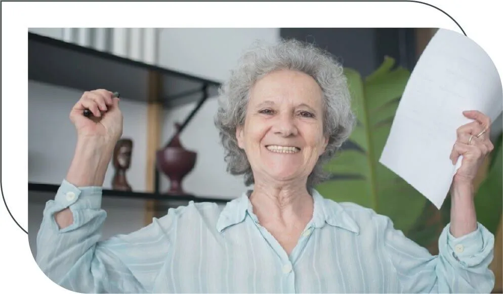 senior woman holding a paper and celebrating