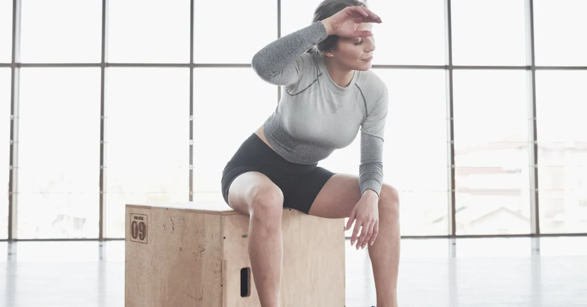 senior woman doing chair exercises on a box in the gym