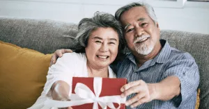 seniors holding out a gift