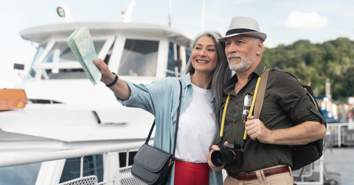 senior couple on vacation in a marina holding a map