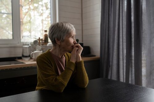 mature lady sitting pondering
